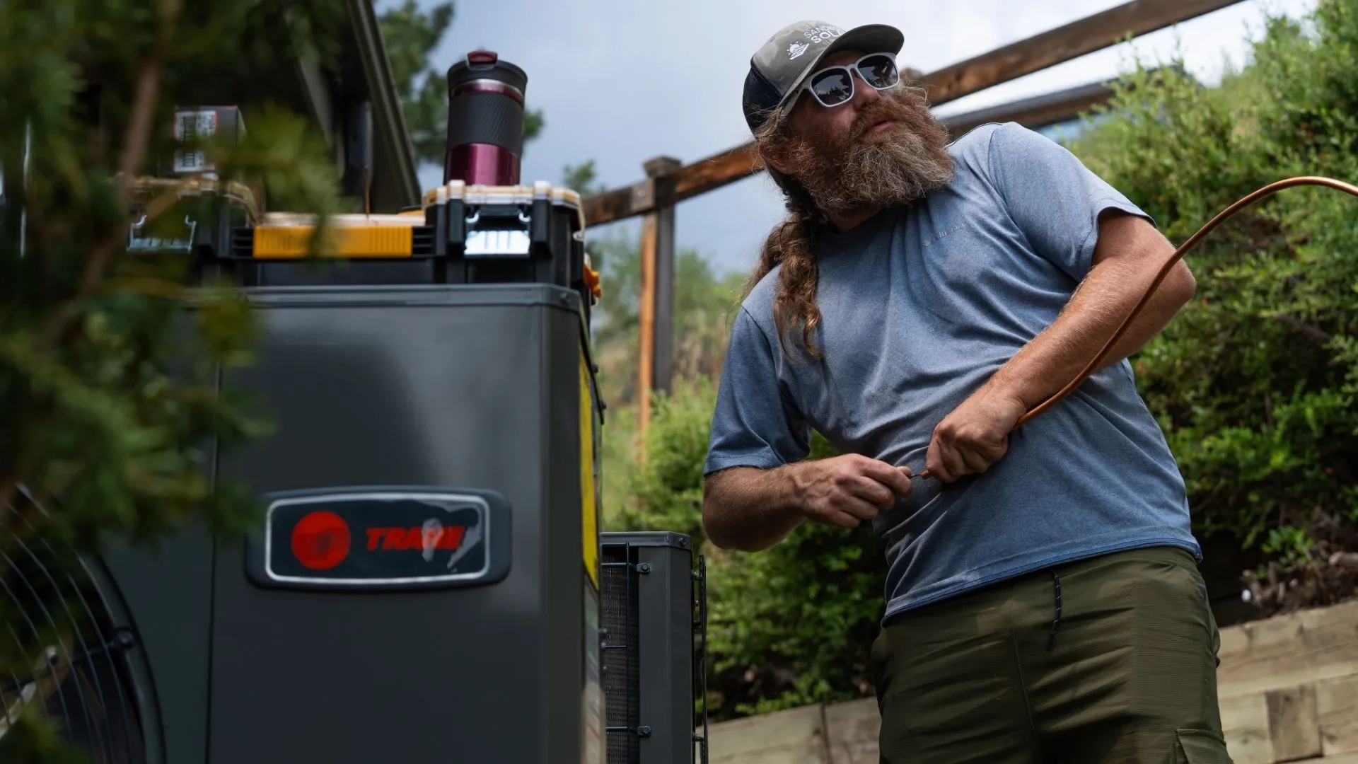 Professional HVAC Technician Installing a Heat Pump System Professional HVAC Technician Installing a Heat Pump System