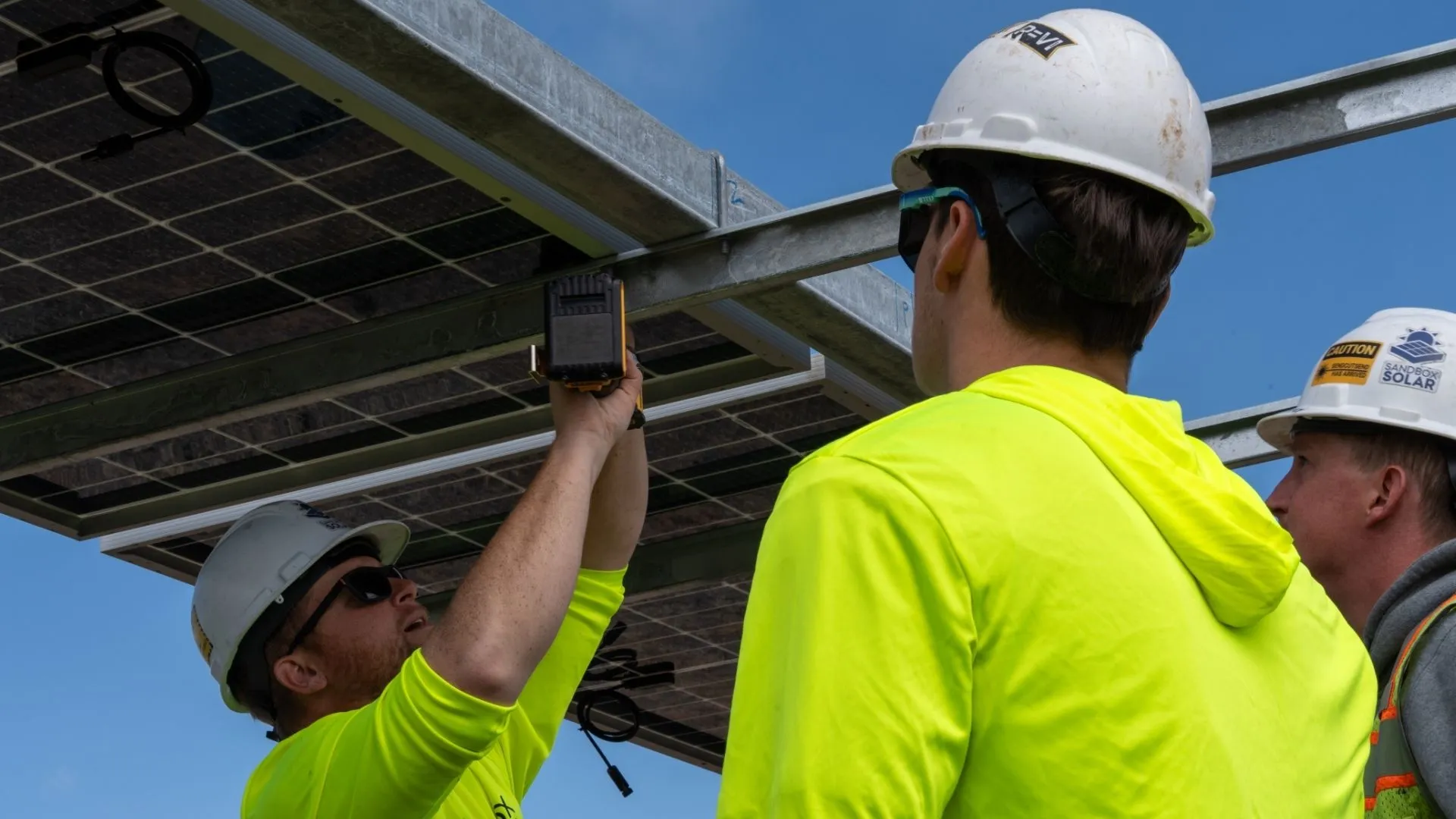 Agrivoltaic Solar Installation Crew Working Together Agrivoltaic Solar Installation Crew Working Together